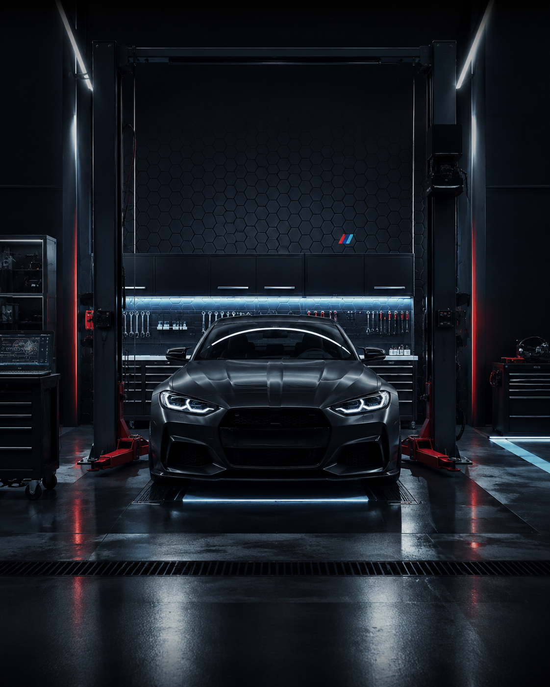 MMS Auto workshop bay with a BMW M coupe under hex-lit panelling